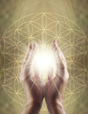 Glowing light held between two hands over a golden Flower of Life geometric pattern.