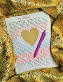 Handwritten journal page with a heart-shaped cutout and a purple pen resting on gold patterned fabric.