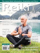 Reiki News Magazine Summer 2023 cover featuring a man meditating on grass by a lake with mountains in the background.